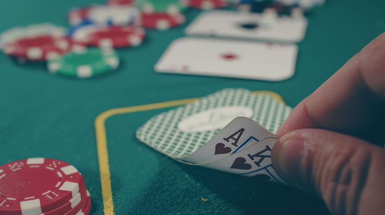 closeup-hand-revealing-ace-king-hearts-poker-game-with-poker-chips-cards-table (1)